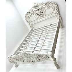 Victorian style small double bed, heavily carved with floral patterns, shaped supports in white finish 