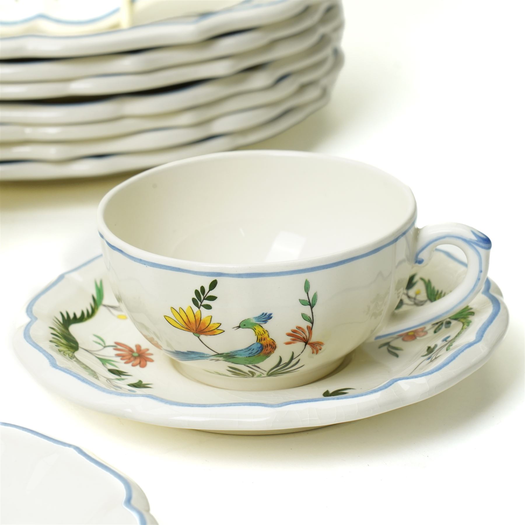 Gien France faience tea and dinner service in the 'Oiseaux de Paradis' pattern comprising six dinner plates, eight dessert plates, eight soup bowls, four cups, six saucers, oval plate, milk jug and sugar bowl and cover