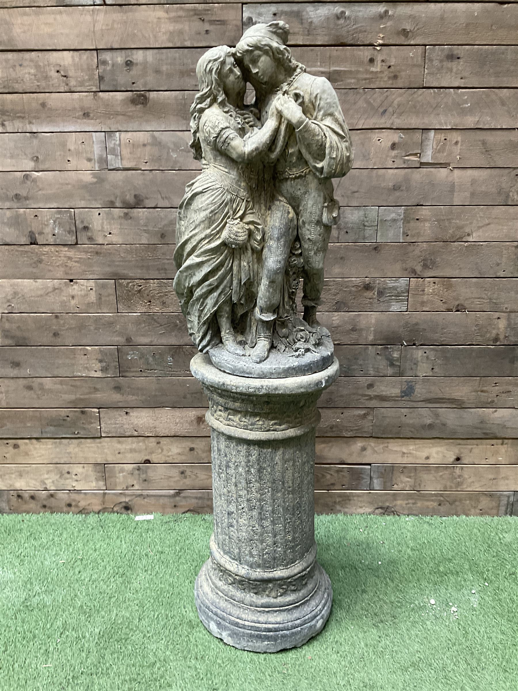 Romeo & Juliet - cast stone garden figure raised on circular fluted column - THIS LOT IS TO BE COLLECTED BY APPOINTMENT FROM DUGGLEBY STORAGE, GREAT HILL, EASTFIELD, SCARBOROUGH, YO11 3TX