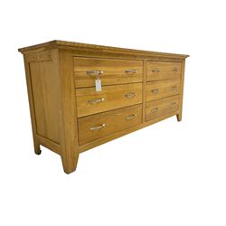 Contemporary wide oak straight-front chest, fitted with a bank of six drawers with chrome handles, on tapered feet
