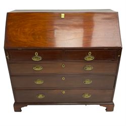 George III mahogany bureau, fall front enclosing interior fitted with pigeon holes, drawers and cupboard, two short and three long cock-beaded drawers below, on bracket feet