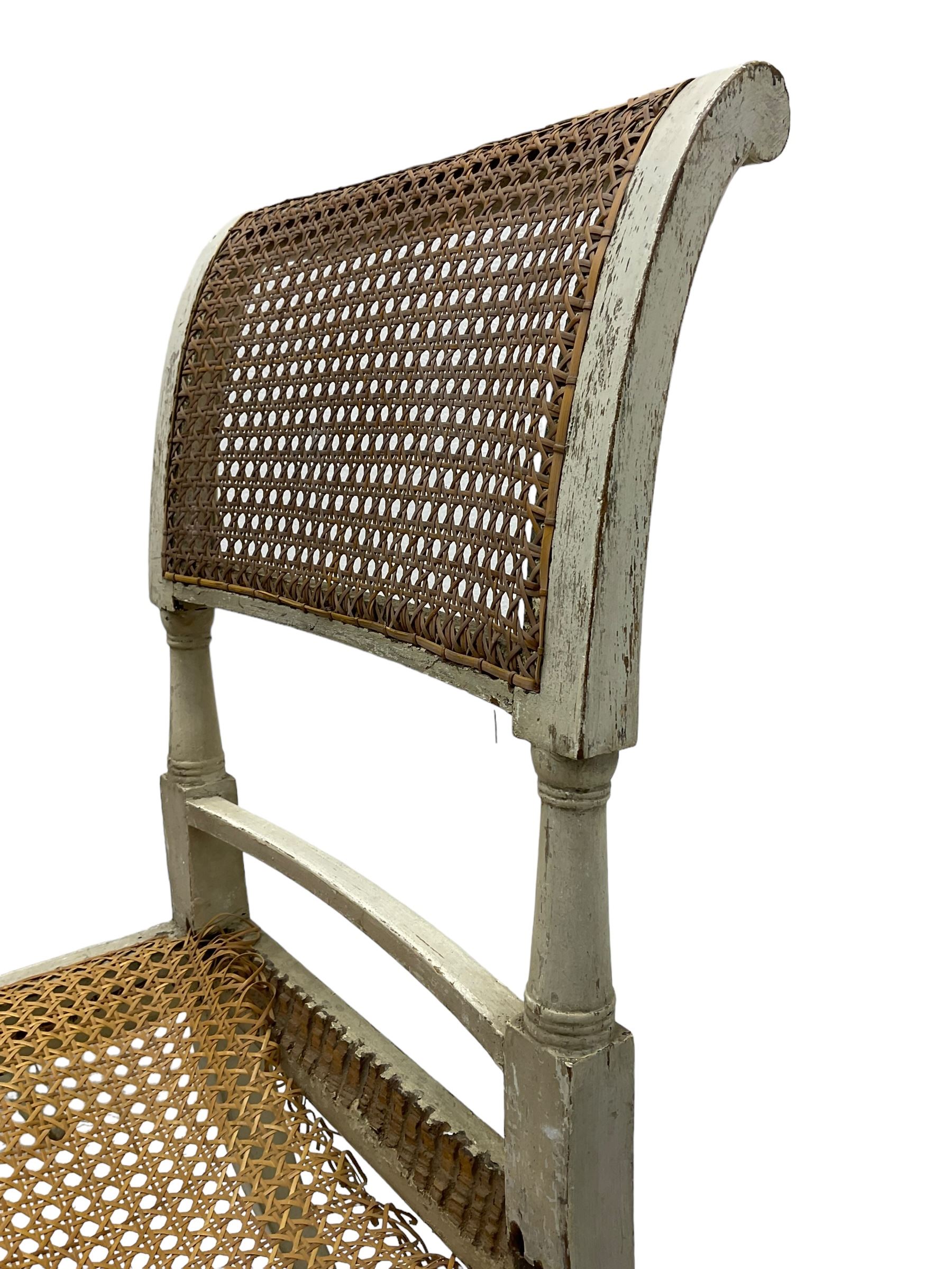 Collection of Regency dining chairs - set of four Regency painted beech dining chairs, with cane seat and back, on collar turned supports with splayed feet (W46cm, H84cm); a pair of Regency ebonised dining chairs (W47cm, H77cm); and a single Regency dining chair, the cresting rail painted with floral cornucopias and central putto vignette, X-frame back over cane seat, on collar turned front supports painted with foliage (W46cm, H84cm) (7)