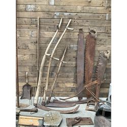 Large quantity of vintage hand tools including scales, scythes, saws etc
