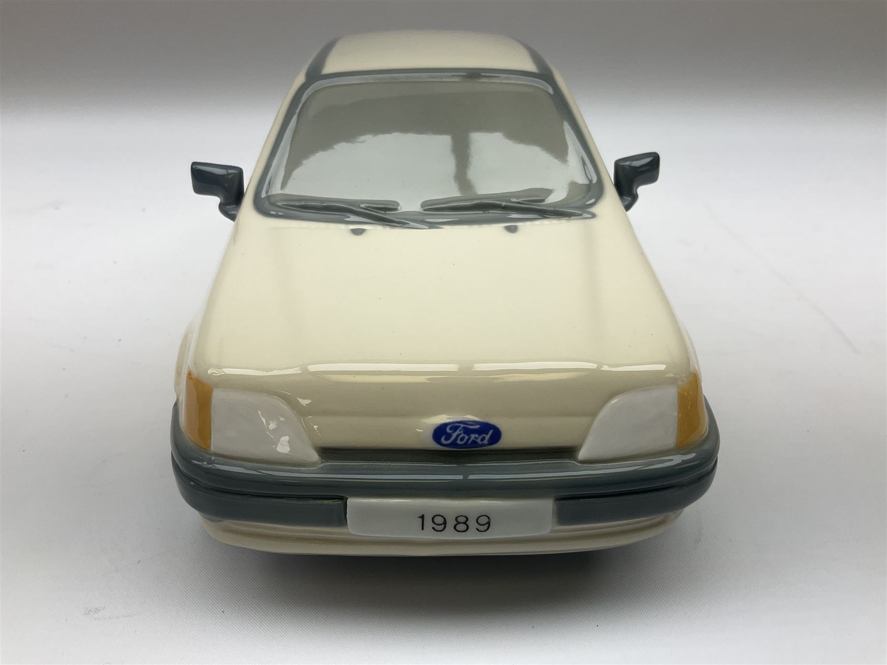 Lladro figure, Ford Fiesta, modelled as a Ford in beige, special commission by the Ford factory in Valencia, original box, no 7608, year issued 1989, year retired 1989, H9cm 