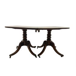Early 19th century mahogany extending dining table, the two D-ends each with moulded rectangular tops on turned pedestals with four carved splayed supports, decorated with draught turned roundels, ornate cast brass cups and castors, with additional leaf