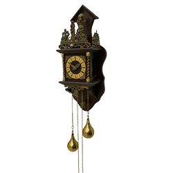 20th century Dutch style Zaanse Zaandam wall clock with a German eight-day weight driven movement housed in a wooden case on a shelf bracket with applied cast brass detail, brass effect chapter ring with Roman numerals , half-hour markers, minute track and cherub spandrels, striking the hours and half hours on a bell. With brass finished weights and pendulum.


