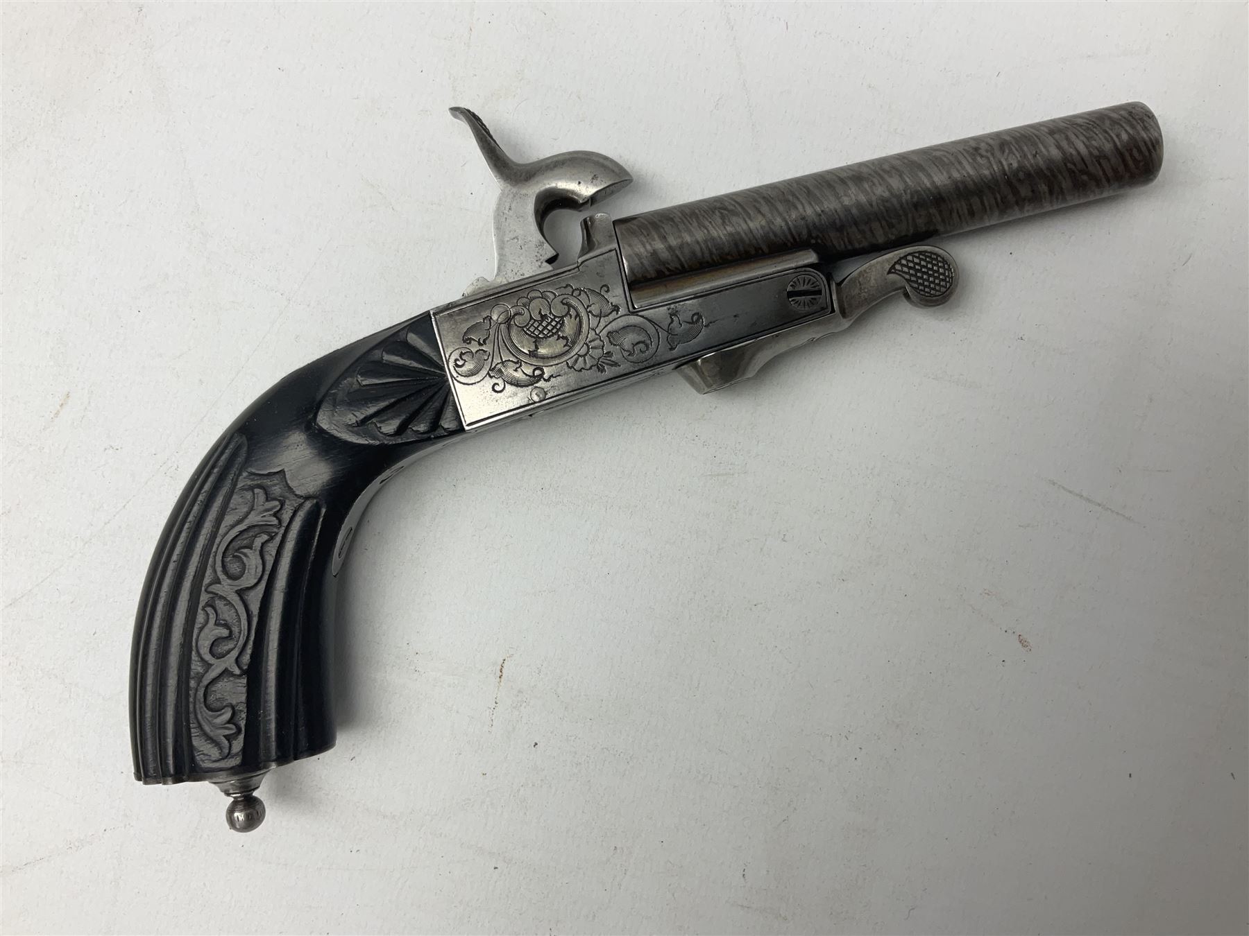 Mid-19th century French Boissy 12mm single barrel pin-fire pistol, the 9.5cm rifled barrel with brown stub twist damascus decoration, side screw under lever opening and English proof marks, retailed by H. Akrill Beverley, chased action with drop-down trigger and carved walnut stock L21cm