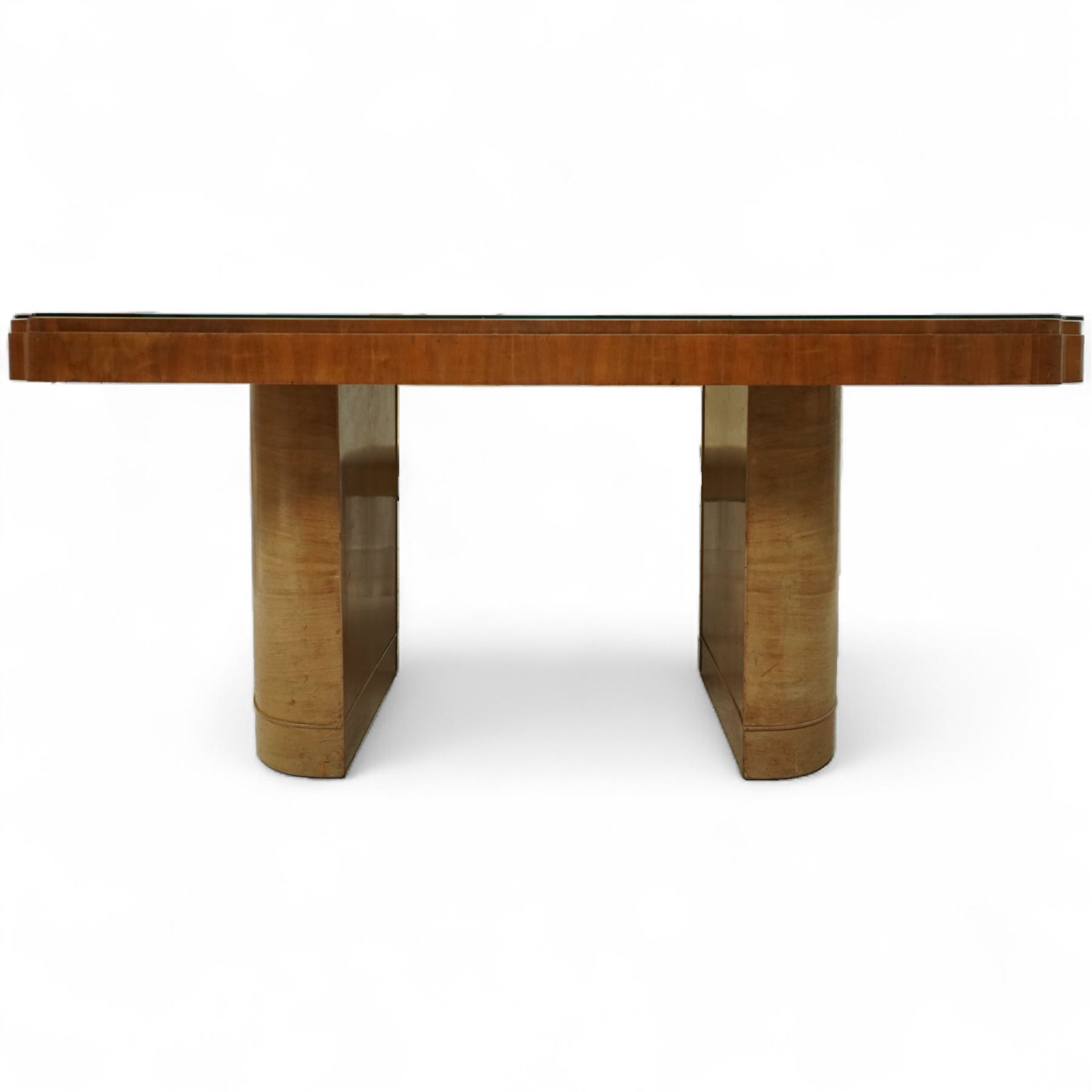 In the manner of Harry & Lou Epstein - Art Deco figured walnut veneered dining table, rectangular top with canted corners and glass protective top, edge with gently canted profile, on two rounded drum-shaped pedestals together with a set of four mid-century style walnut chairs, with elegant scroll and walnut veneered backs, upholstered in a light cream leather, 54x44x96cm