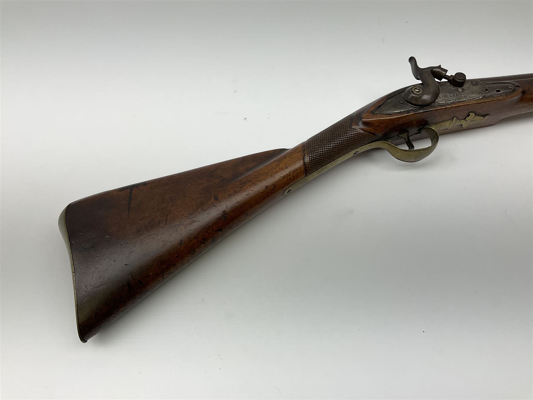 Early 19th century 15-bore flintlock converted to percussion cap fowling piece, the lock stamped T. Richards, walnut half stock with brass fittings including trigger guard with pineapple finial and 91cm barrel with ramrod under L129cm overall