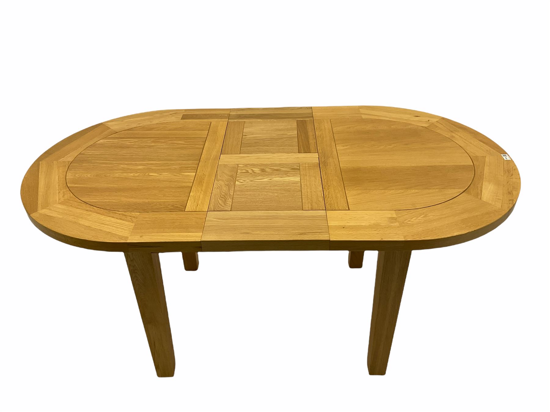Solid oak oval extending dining table, butterfly leaf extension, four chairs with brown upholstered seats