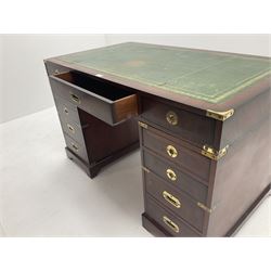 Mahogany campaign style kneehole desk, inset leather top, eleven graduating drawers, shaped plinth base 