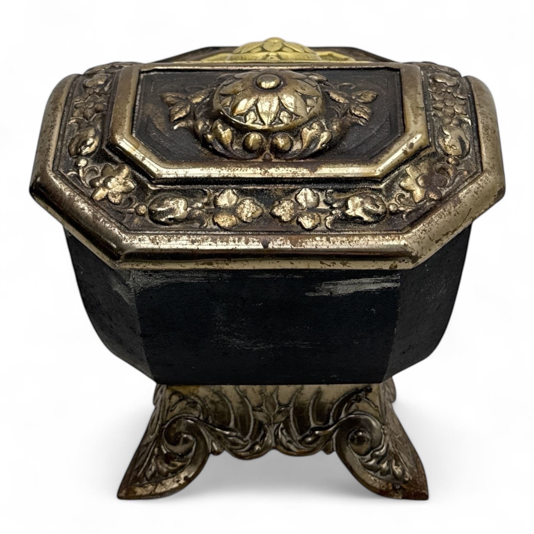 Late 19th century Victorian cast iron and brass purdonium, domed lid with central embossed sunflower and foliage panel within a floral border, flanked by scrolled and foliate detail, raised on shaped feet
