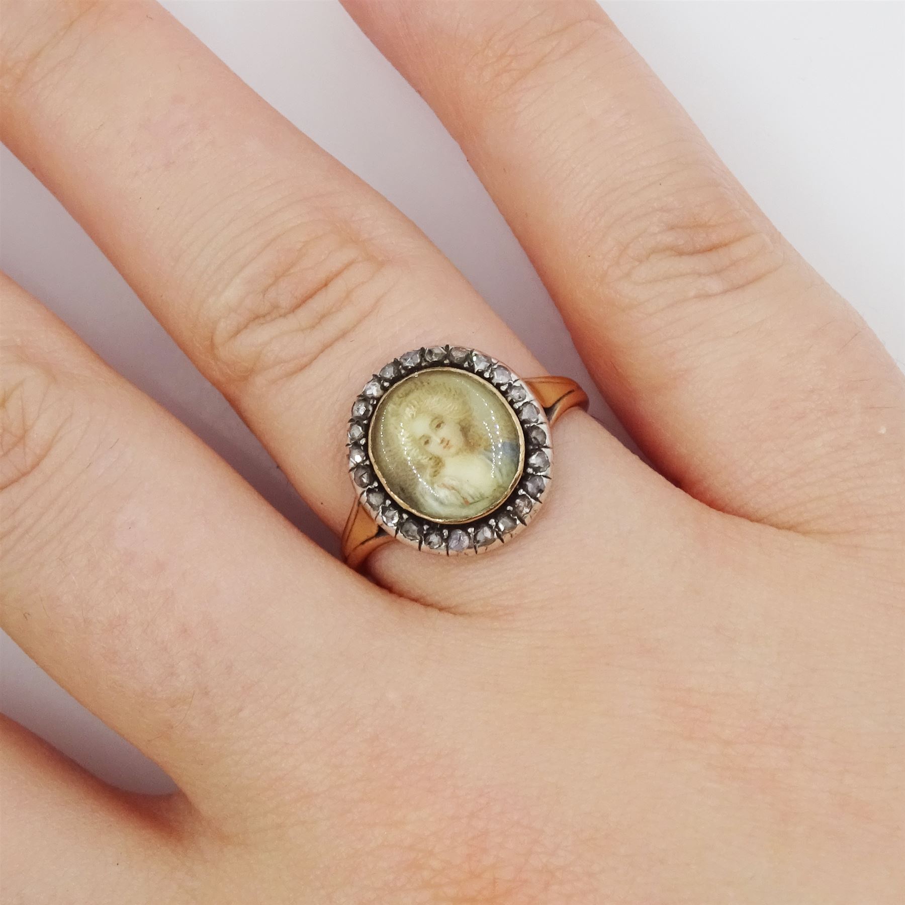 19th century French 18ct gold and silver diamond portrait ring, set with an oval miniature of a woman in 18th century dress on ivory, under a glazed panel, with rose cut diamond surround and trifurcated shoulders, hallmarked. This lot has been registered for sale under Section 10 of the APHA Ivory Act