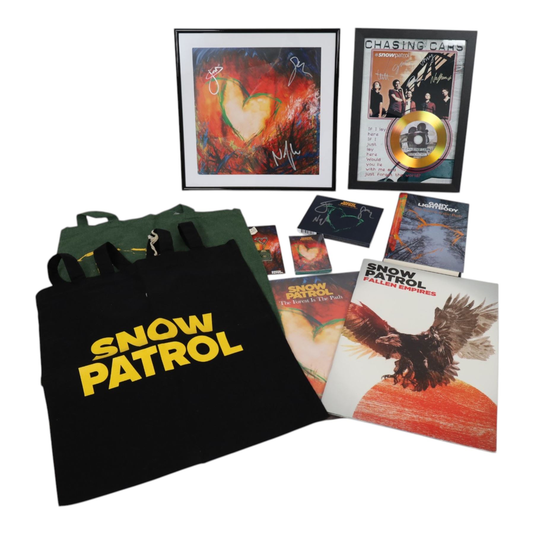 Snow Patrol memorabilia, including 'The Forest is the Path' book, art card and CD cover the book signed by  Gary Lightbody and the others signed by Gary Lightbody, Johnny McDaid and Nathan Connolly, together with Fallen Empires tour programme, tour advert, two tote bags, enamel pins, cassette and framed Chasing Cars gold coloured CD with printed signatures