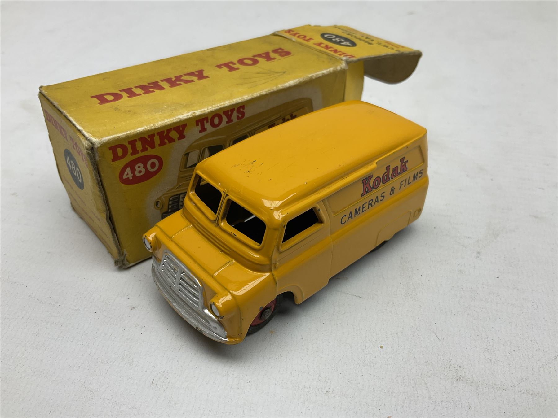 Dinky - Bedford 10cwt Van 'Kodak' No.480, boxed; and six unboxed and playworn models including Trojan Chivers Jellies van, loudspeaker van, Daimler Ambulance, N.C.B. Electric Van and two buses (7)