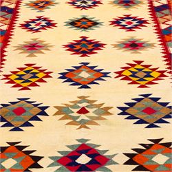 South West Persian Qashqai flatweave kilim, ivory field decorated with rows of multicoloured stepped diamond medallions composed of angular geometric motifs, enclosed by bold polychrome borders of triangular devices and stylized geometric, ornamentation, with fringe ends 