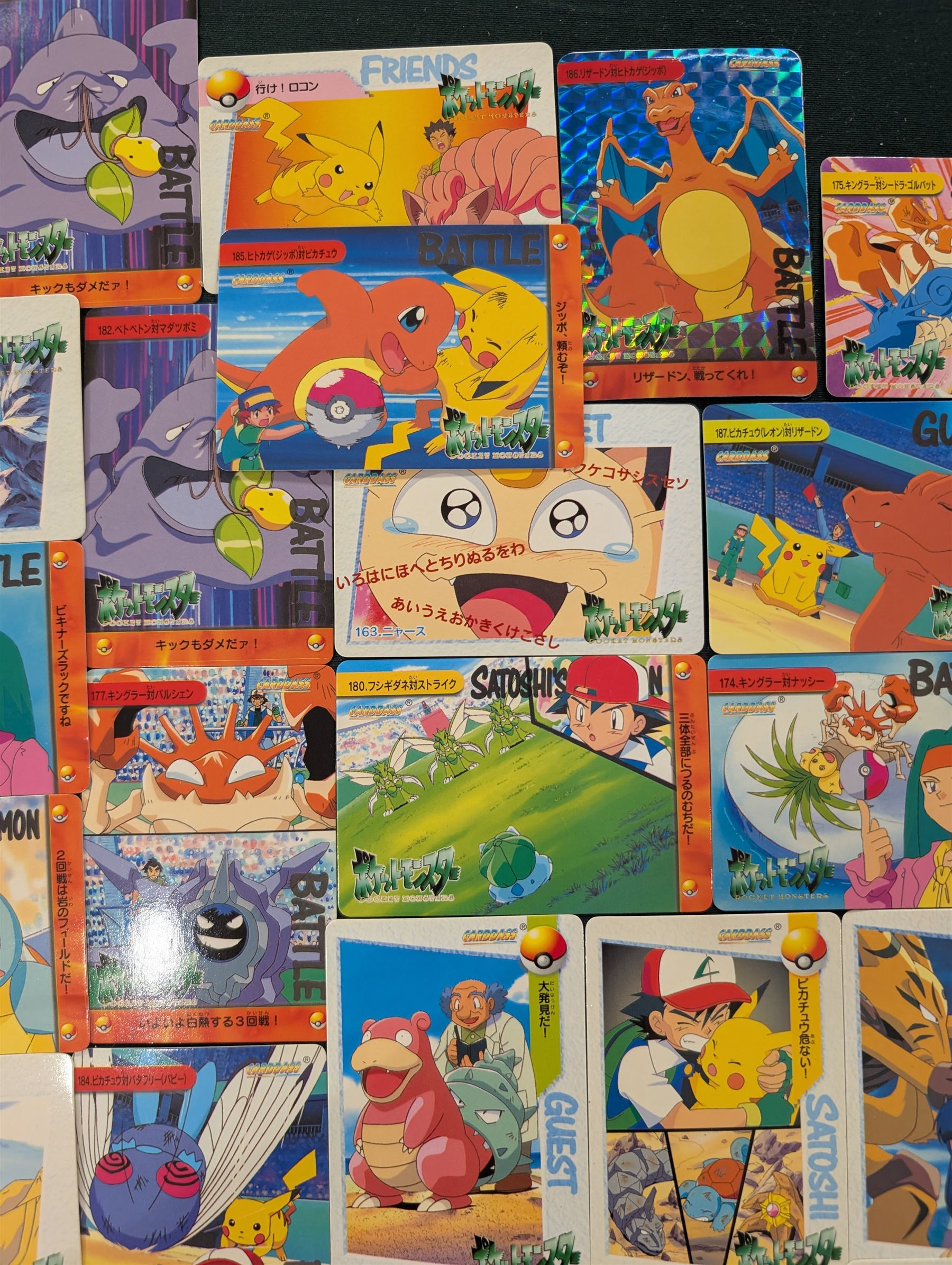 Collection of Pokemon TGC trading cards, including two WB First Movie Black Star promo cards Pikachu no. 4 and Dragonite no. 5, two Ancient Mew Black Star holo promo cards, Gym Challenge Giovanni's Persian 8/132 holo and a small collection WOTC, Neo Discovery and Neo Genesis cards, together with thirty four Bandai Carddass Pokemon cards, including prism Charizard no. 186 and Pokemon Topps cards including holo examples 