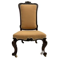 Victorian rosewood nursing chair, the cresting rail carved with scrolling foliage and flower heads, on scroll carved cabriole front supports, the rear castors cast with shell motifs (W55cm, H106), and two mirror