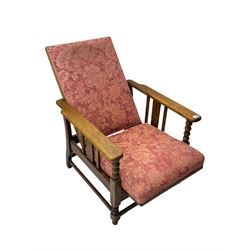 Early 20th century oak reclining armchair, upholstered in floral patterned fabric 