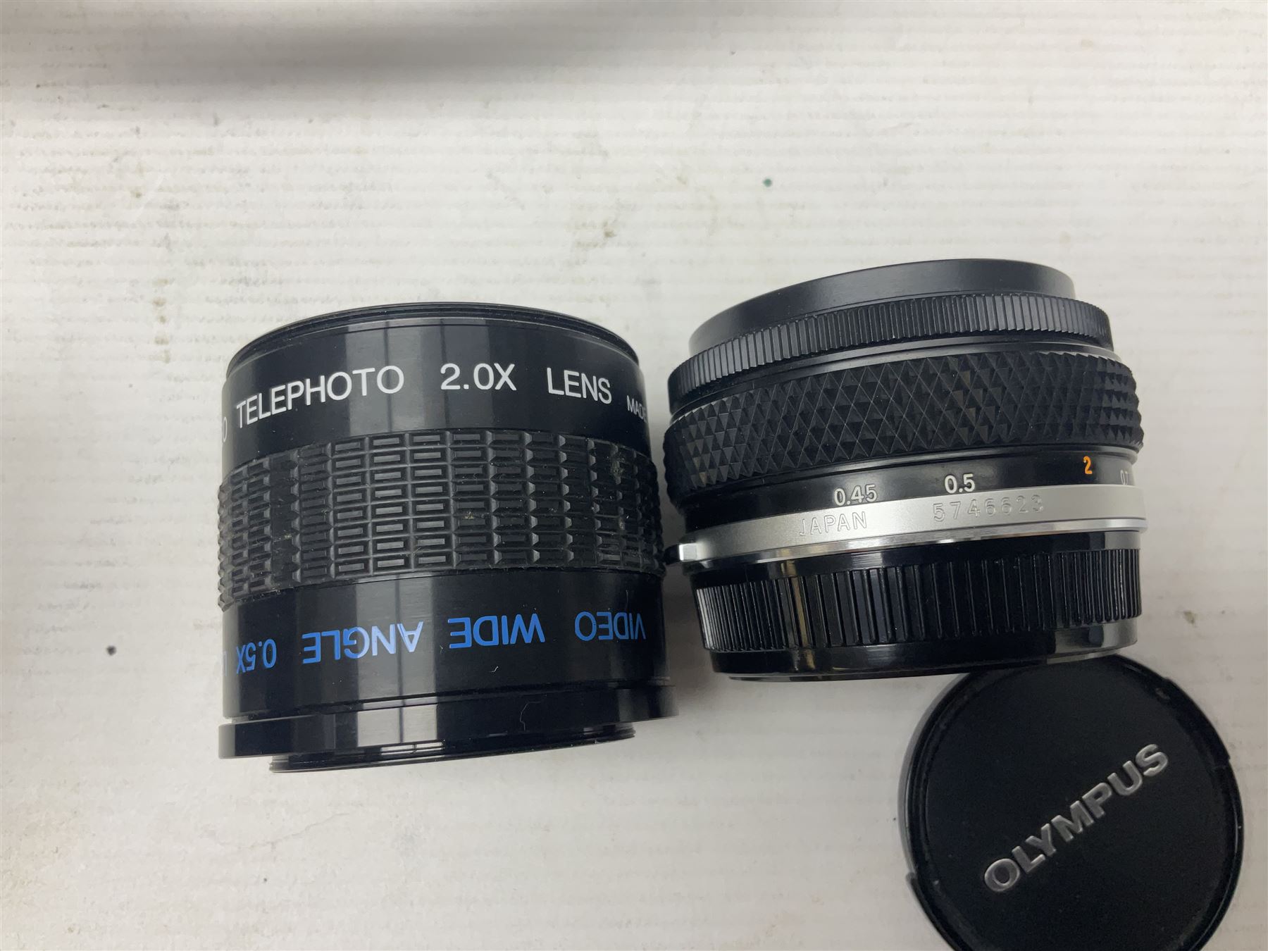 Olympus OM-2 camera body, serial no 1117526, with Olympus OM-System Zuiko Auto-W 28mm 1:2.8'  lens serial no 336591, Olympus OM10 camera body serial no 2392257, with Olympus OM-System Zuiko Auto-Macro 50mm 1:3.5' lens serial no 225784, Soligor C/D mirror lens 1:8 f=500mm' serial no 784035650 together with other camera equipment 