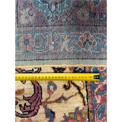 Northwestern Persian Meshkin hand-knotted carpet, the ivory field with an all-over design of scrolling vines and stylised floral sprays in burgundy, pink, and blue tones, enclosed by a raspberry red border of rosettes and palmettes linked by fine arabesques, from the region of Meshkin near Ardabil