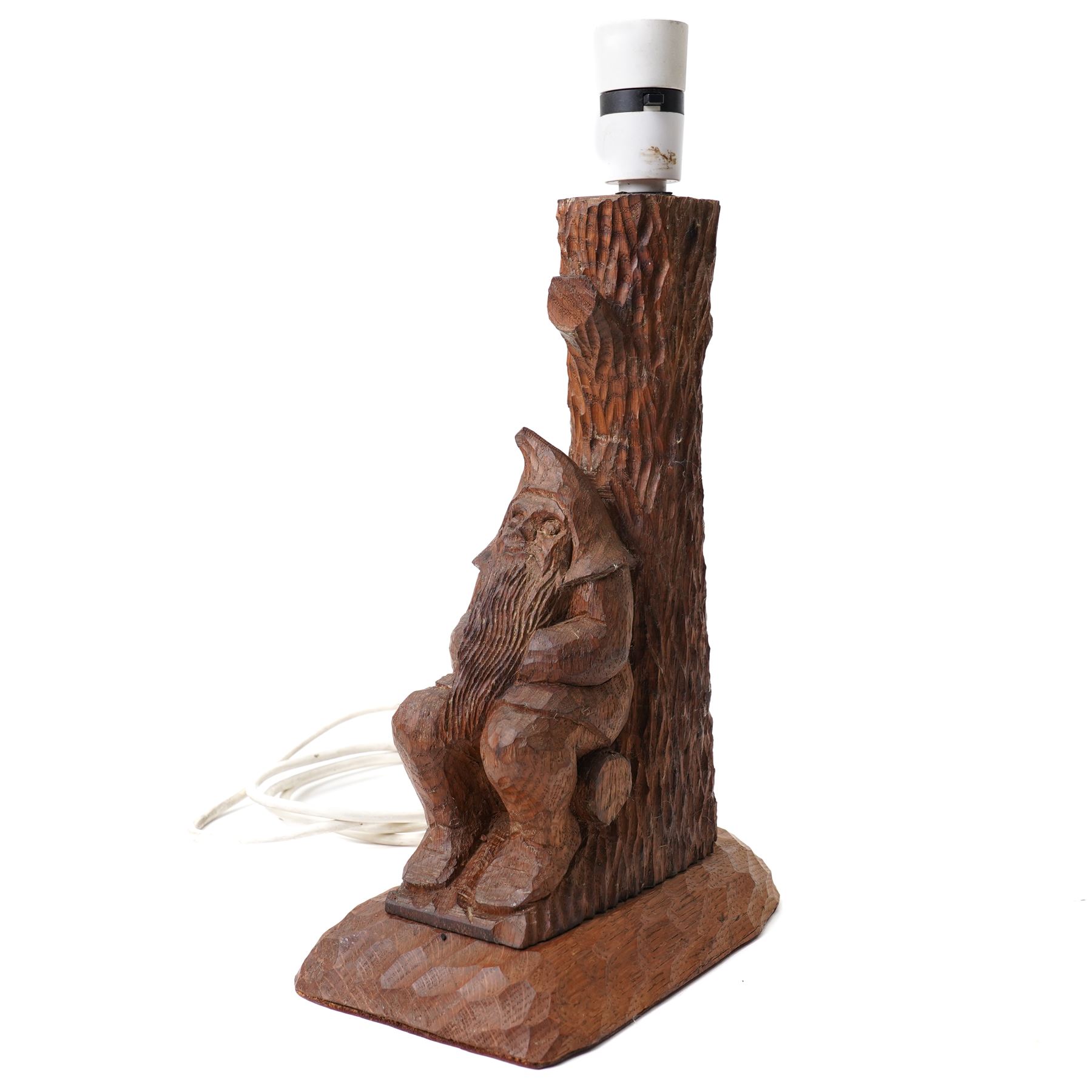 Gnomeman - an oak table lamp, with carved gnome figure seated on a log at the base of a tree stump, on a tooled base, by Thomas Whittaker of Littlebeck, H28cm excluding fitting