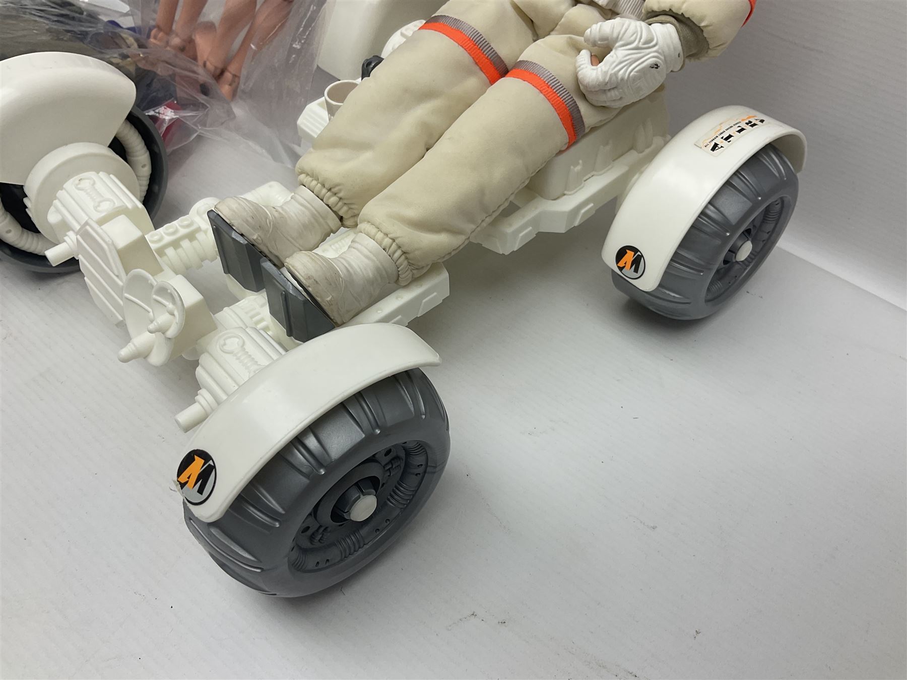 Action Man - large collection of 1960s and later figures and accessories including Spaceman with ATLRV vehicle; two figures marked 'Made in England by Palitoy under licence from Hasbro 1964'; twenty-five assorted weapons; radio backpacks; kit bags; twenty-one pairs of boots; football boots and snow shoes; metal diver's boots and three pairs of flippers; two pairs of jackboots; roller skates; various tunics, trousers, flying suits, jumpers, belts etc; twenty helmets, berets, busby, kepis, submariner etc; and quantity of other accessories