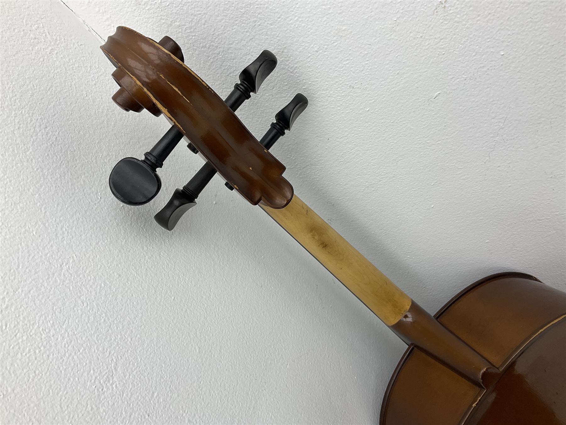 Modern Romanian student's three-quarter size cello with 70cm two-piece maple back and ribs and spruce top, bears label 'Musikinstrumentenfabrik Reghin Romania' L115cm overall