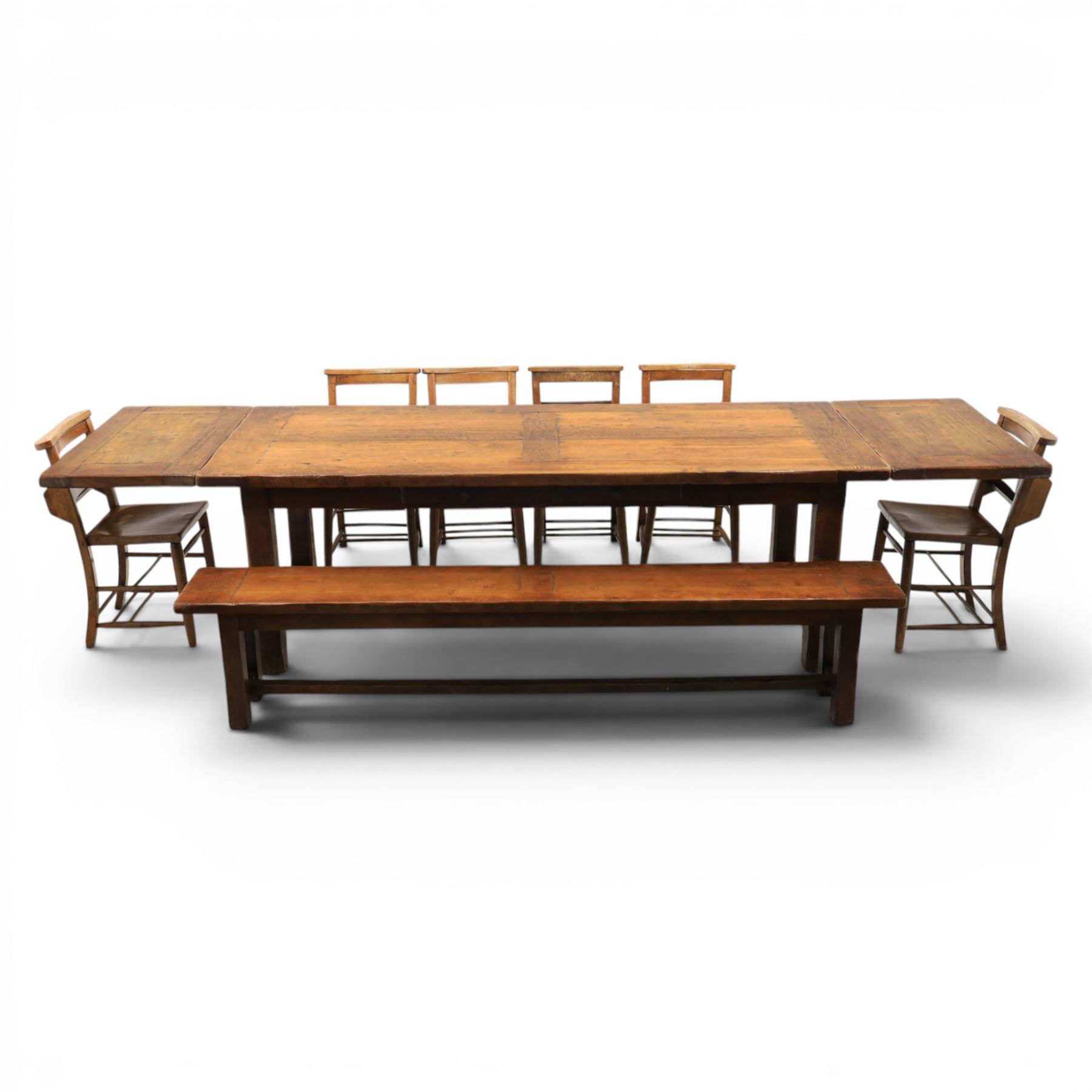 Country pine draw leaf table, bench seat and six chapel chairs, the top of plank construction, with two frieze drawers, additional leaves extending to 320cm, with bench seat and six elm chapel seats