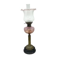 Victorian table oil lamp with black glazed stepped circular base, reeded brass column, moulded pink glass reservoir, duplex burner and frilled rim frosted glass shade with clear glass chimney H69cm