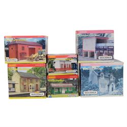 Fourteen Hornby Skaledale 00 gauge model railway trackside buildings, comprising R8504 Holly Farm Cottages, R8501 Ravenn Cottage, R8655 Lock Side Stores, R8550 Ticklepenny Cottage, R8719 Lower Skaledale Waiting Room, R8602 Holly Farm Barn, two R8633 Covered Coal Shed, R8525 Holly Farm Stables, R8629 Station Building, R8571 Road Over Bridge, R8856 Skaledale East Waiting Room, R8990 Cricket Pavillion and R8682 Greenhouse, all boxed