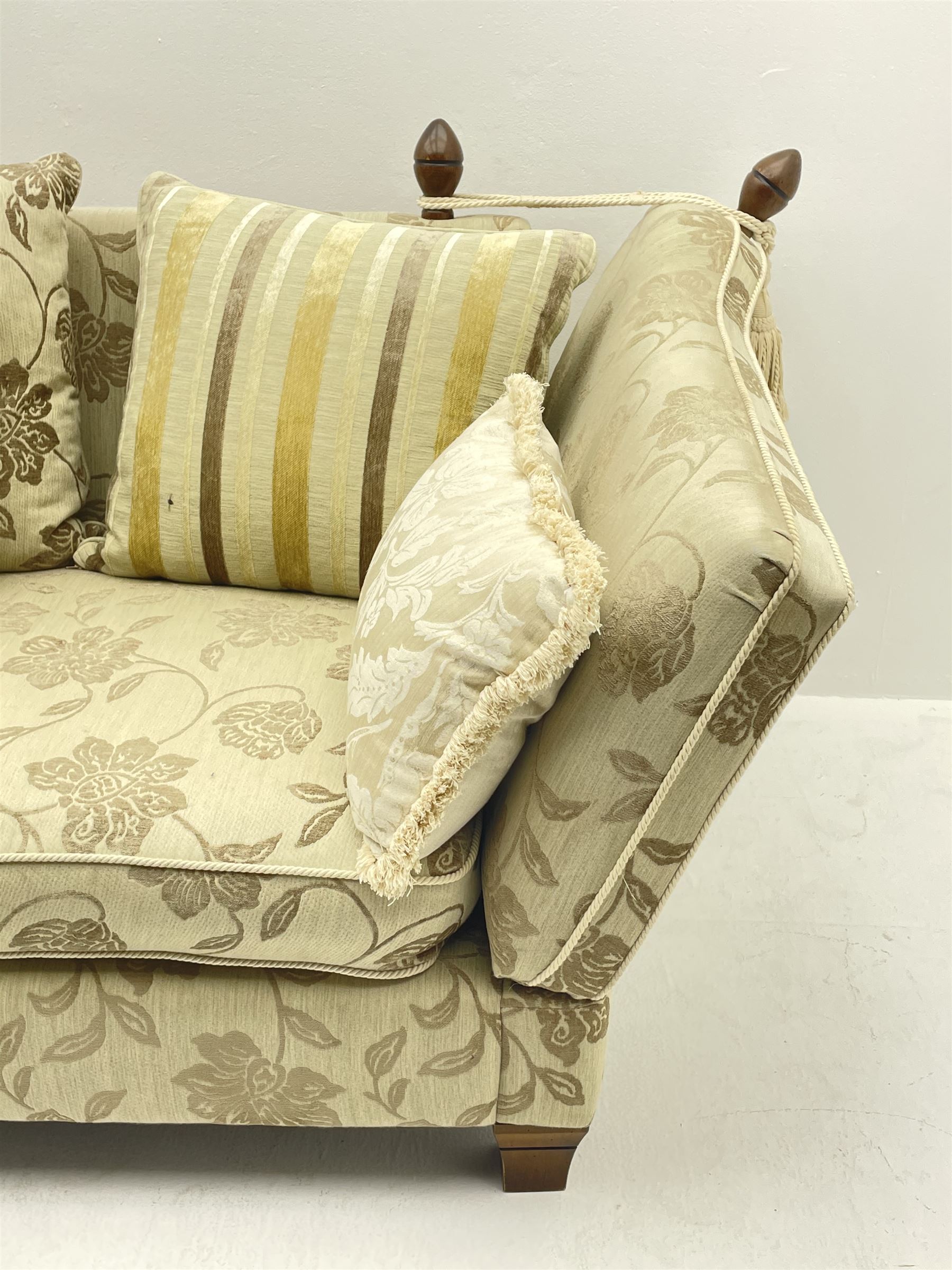 Grande Knole drop arm three seat sofa upholstered in pale fabric with raised floral pattern, with feather scatter cushions