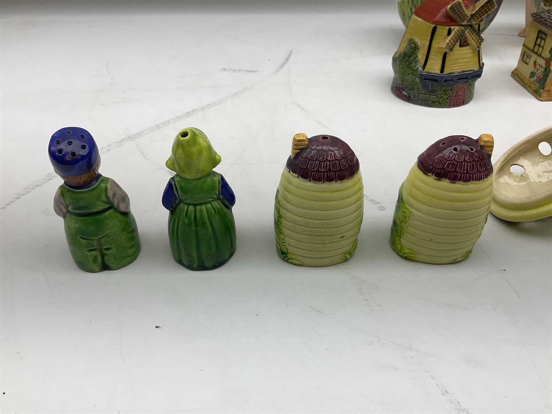 Collection of Japanese Maruhon ware novelty preserve pots, to include examples modelled as a windmill and cottages, together with other 1920s and 30s Art Deco style preserve pots, etc