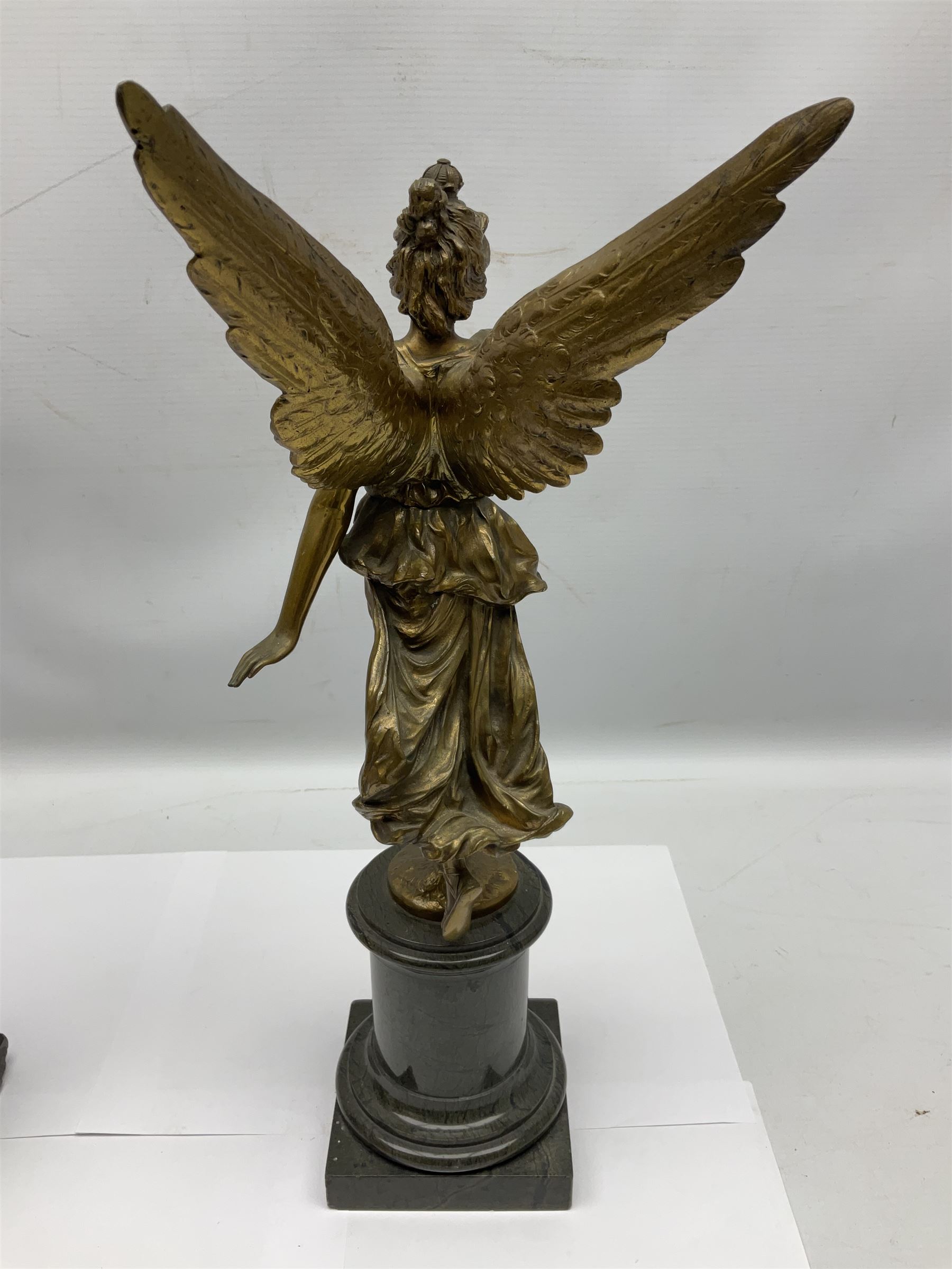 After Oswald Schimmelpfennig (German, 1872-1939): Pair of gilt bronze winged Allegorical female figures, the first example with arm outstretched holding a branch, signed 'Schimmelpfennig 1900', the second with arm raised above her head holding a book and sword in the other, both raised upon marble plinths, H45cm