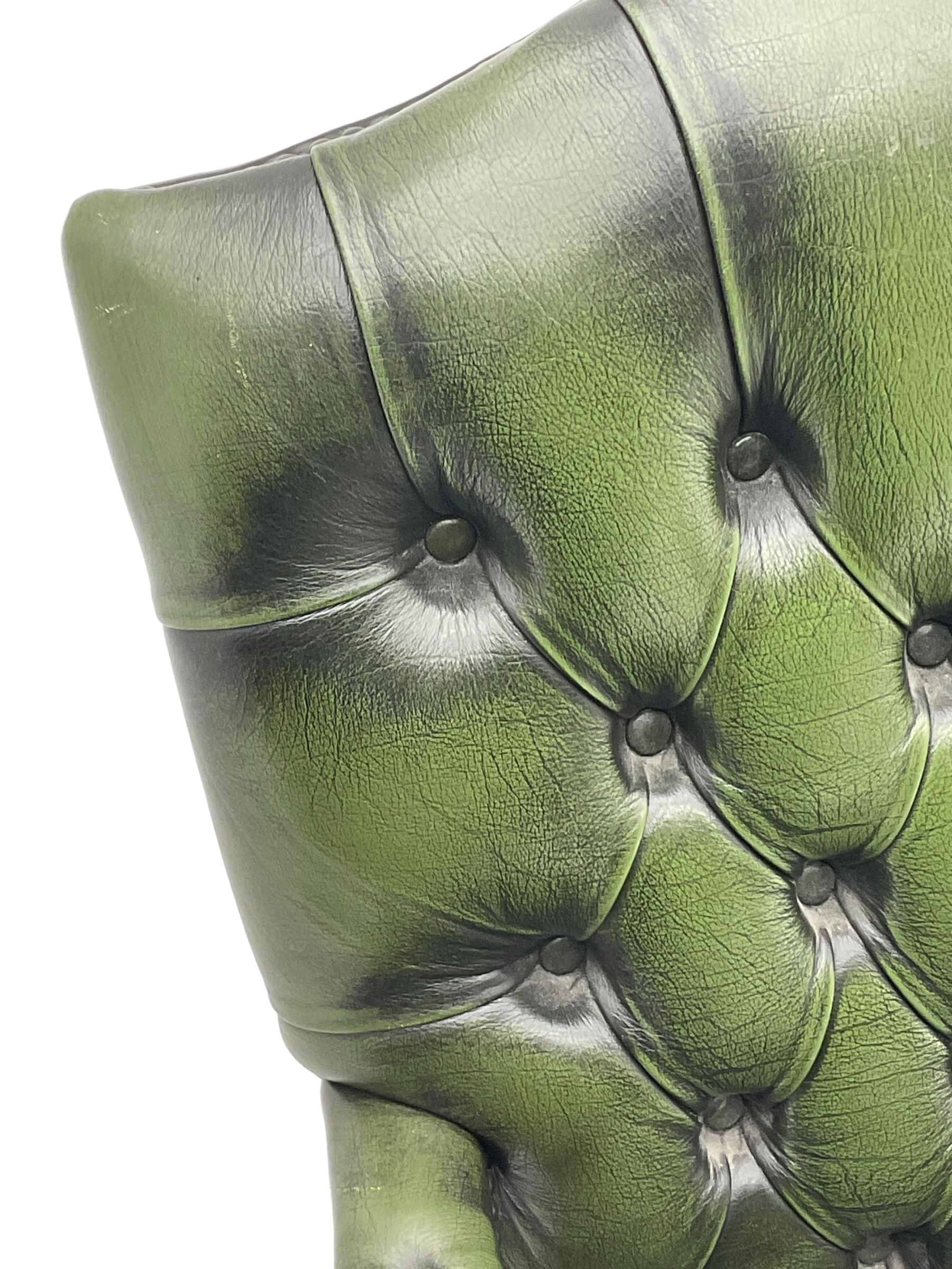 Georgian design swivel office desk chair, upholstered in buttoned green leather, on five spoke base with castors 