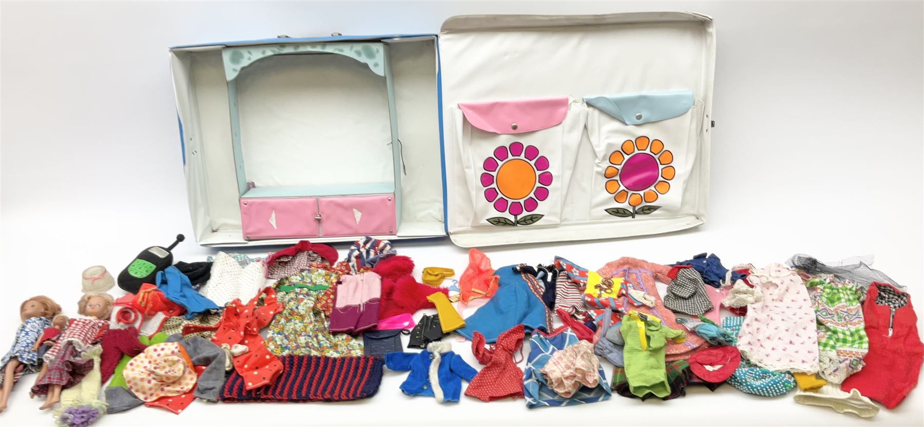 The World of Barbie Double Doll Case containing a quantity of assorted doll's clothing; together with two large and one small fashion dolls.
