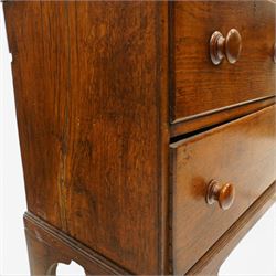 18th century oak larder cupboard, projecting moulded cornice over two panelled doors with shaped arched fielded panels, three short dummy drawers above base fitted with two short and one long drawer, turned handles, on bracket feet
