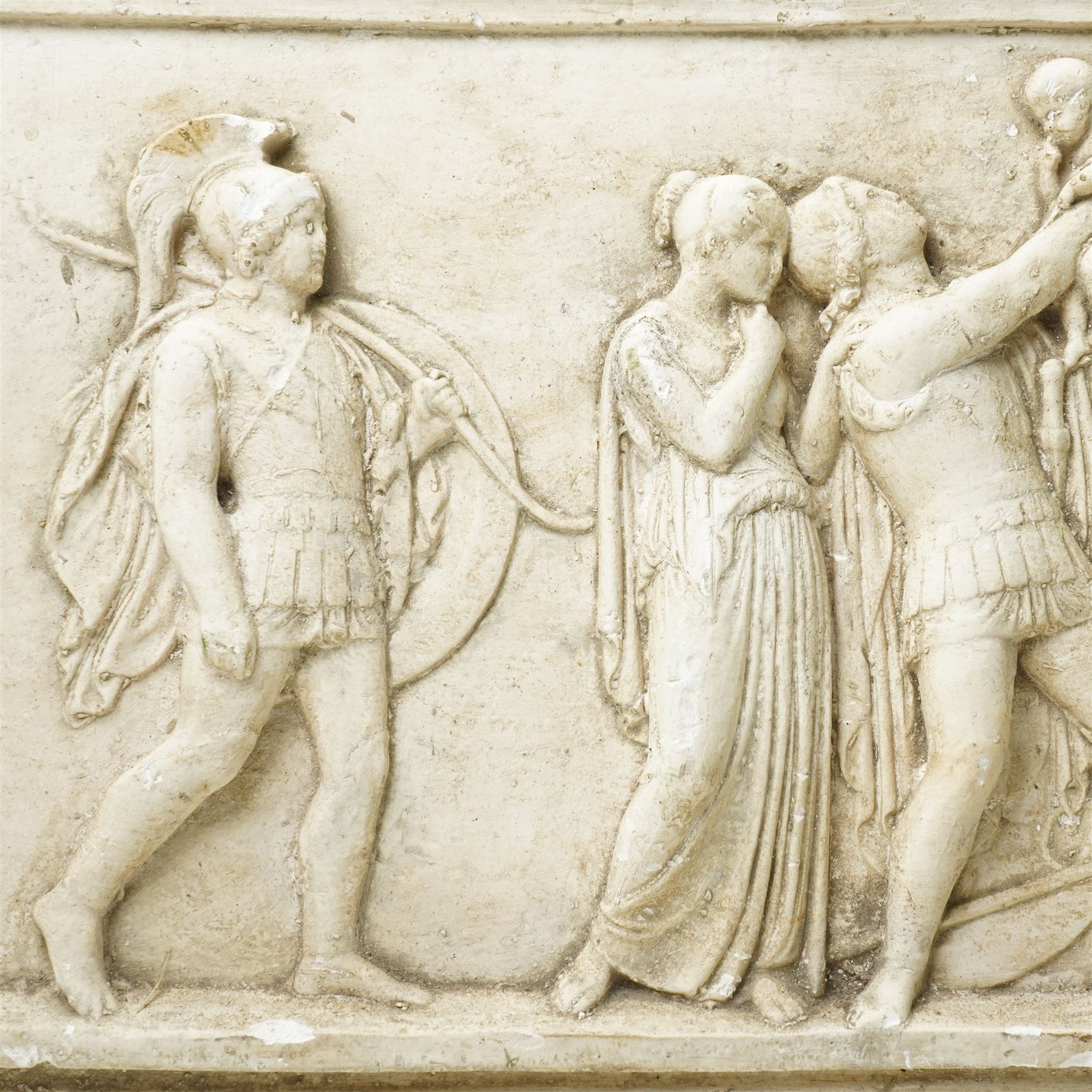 After the Antique - Relief moulded plaster plaque of Roman figures, one holding a child aloft 31cm x 55cm