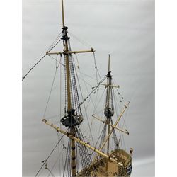Wooden kit built model of HMS Neptune, 1:90 scale, with detailed rigging to three masts and a row of cannons to either side, upon ebonised wooden base, including stand H71cm