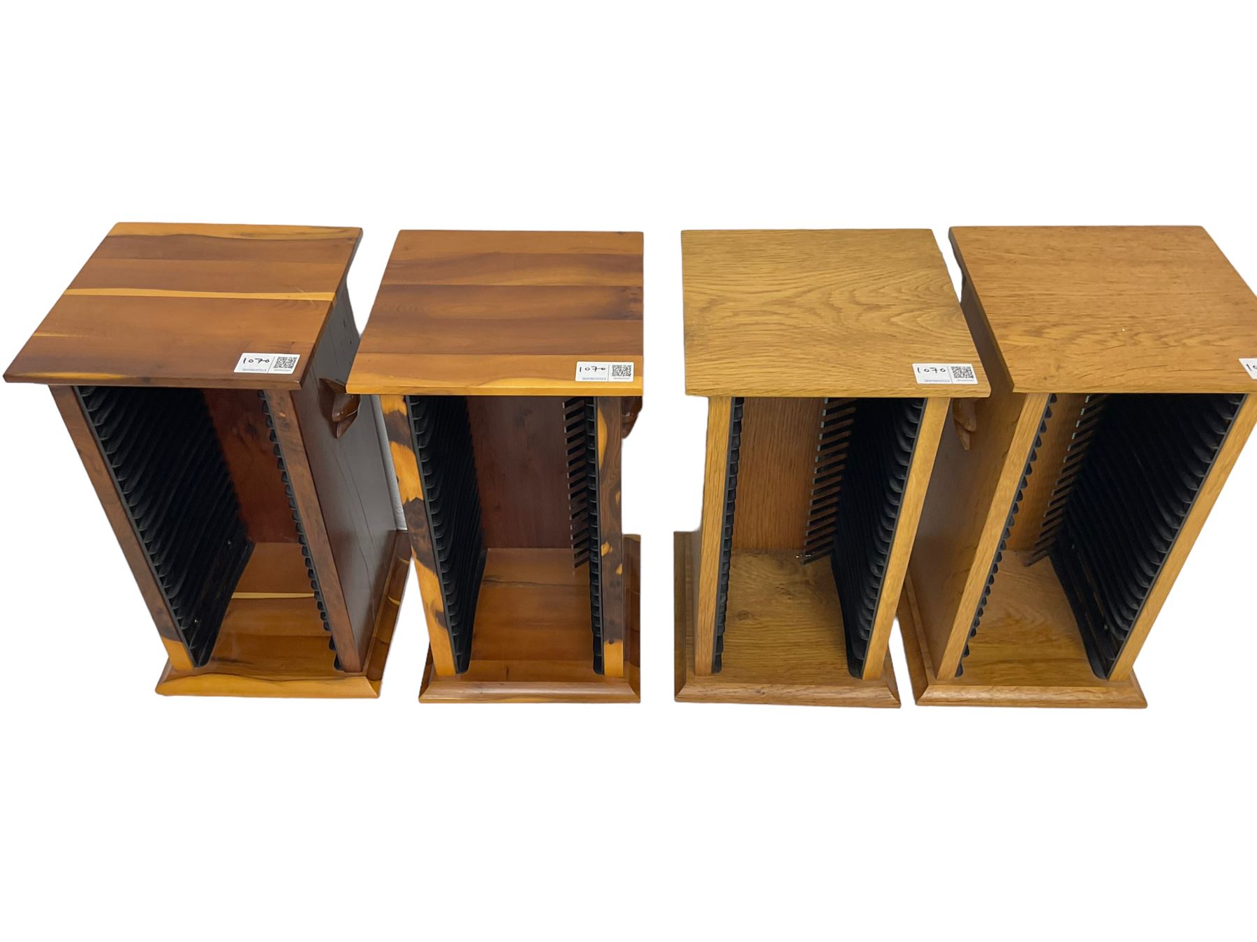 Unicornman - yew wood cabinet, moulded hinged lid over two panelled doors and shelves (W56cm, H99cm, D45cm); and four Unicorn man CD racks two in yew wood and two in oak (W20cm, H36cm, D20cm); all carved with unicorn signature and by Geoff Gell, Coxwold
