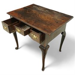 18th century oak lowboy, the three frieze drawers fitted with later brass handles, over shaped apron and cabriole legs with pad feet