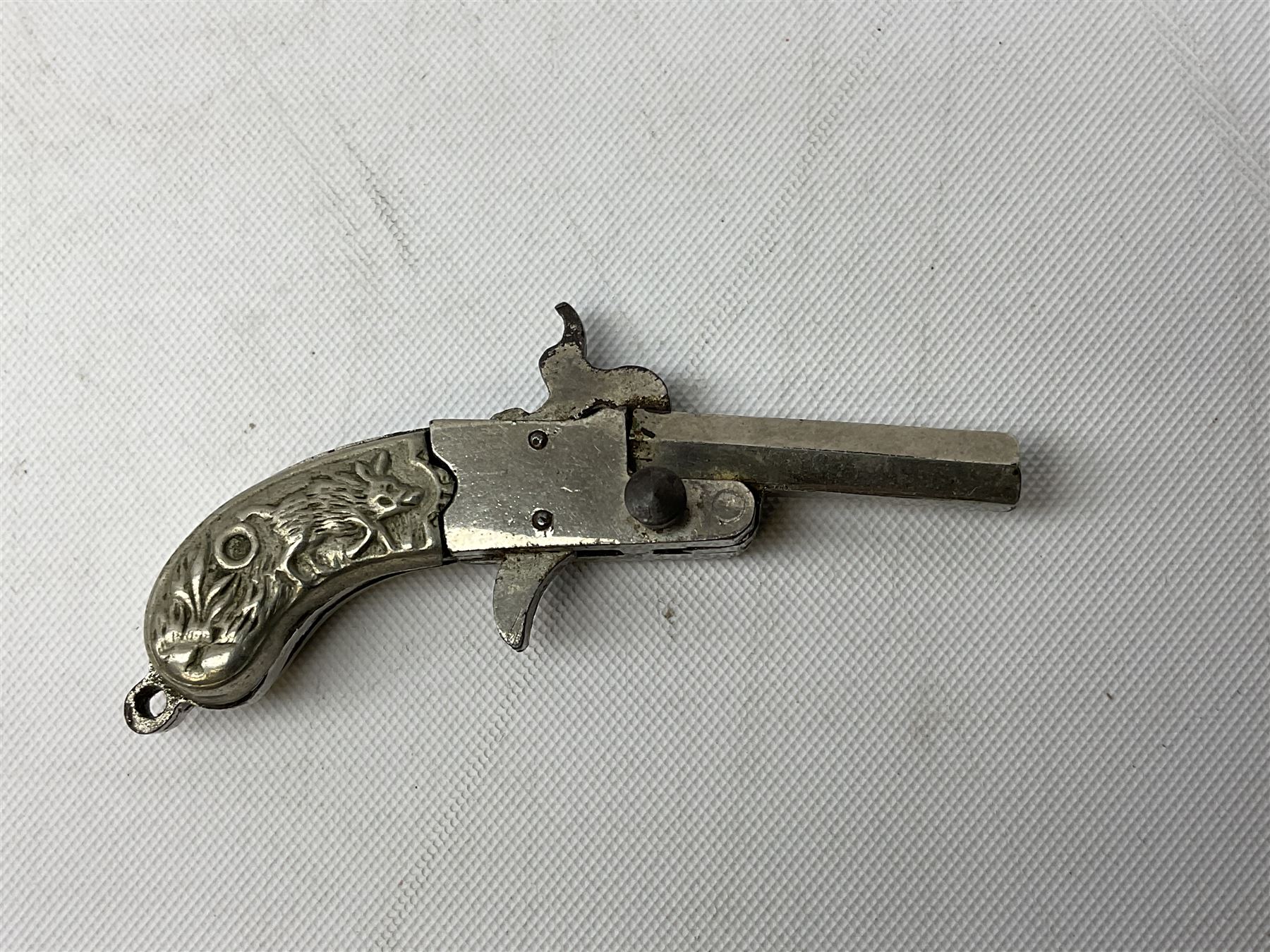 Miniature all nickel 2mm pin fire single shot pistol with engraved grip L4.5cm; together with a .925 silver half hunting cased keyless wind pocket watch inscribed 'Presented to Pte. P. Sizer By No.2 Company 1st Battalion Lincolnshire Regmt For Gallant Conduct Nr. Cork (Ireland) 31.7.20' (2)