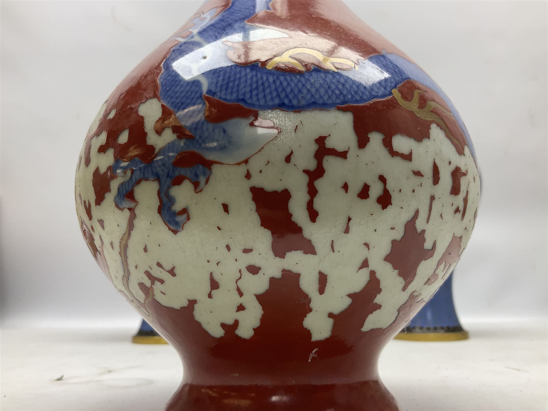 20th Century Japanese vase decorated with a blue dragon and gilding upon red yellow ground, bears Fukagawa Seiji mark (a/f), together with pair of blue cloisonné vases of baluster form decorated with blossom, and pair of Japanese vases, tallest H26cm