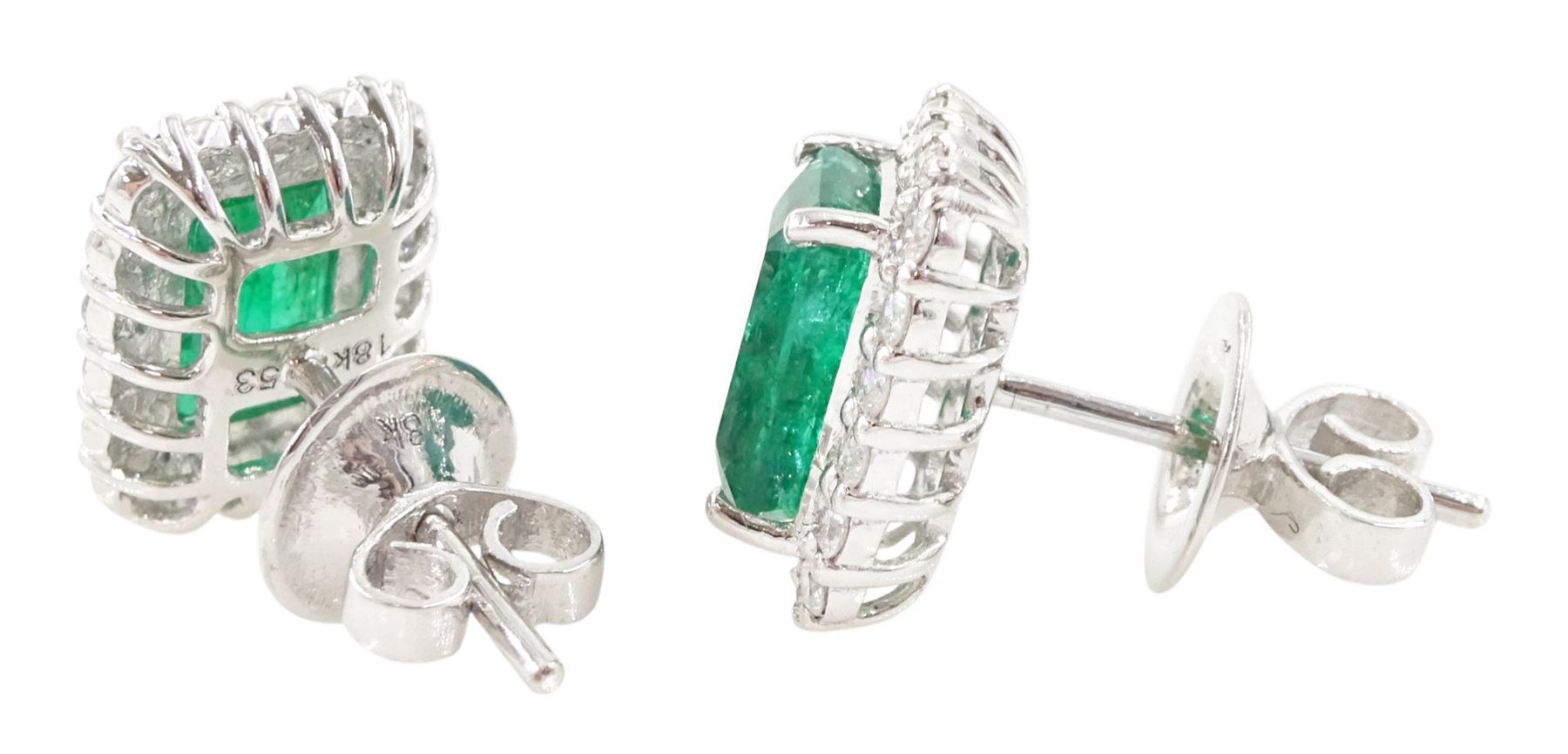 Pair of 18ct white gold emerald and diamond cluster earrings, each stud set with a single octagonal cut emerald, with round brilliant cut diamond surround, stamped, total emerald weight approx 3.00 carat