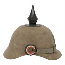 WWI Prussian 57th regiment Ersatz felt Pickelhaube, the grey felt skull with steel spike finial, stitched with green felt 57, chin strap, one side with a black cockade, the other black and red