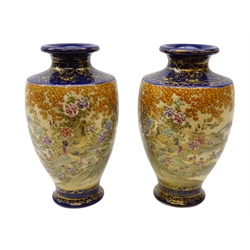  Pair Japanese Satsuma baluster shaped vases, Meiji period, each decorated with two panels depicting Peacocks and ducks in a blossoming garden overlooking a mountainous landscape, on cobalt blue ground with gilt work, seal mark to base, H22.5cm (2)  