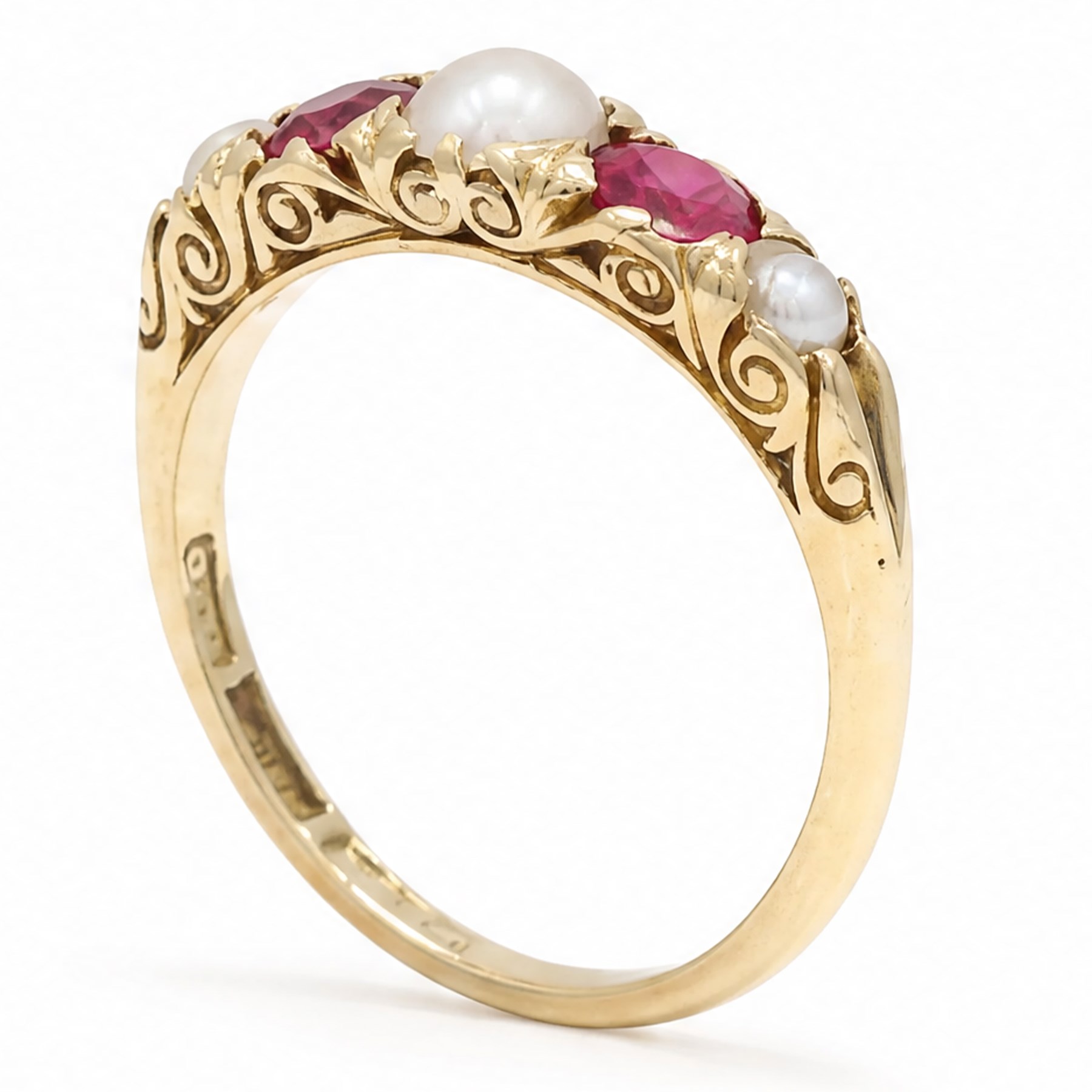 Early 20th century synthetic ruby and pearl ring, set with three split pearls and two round cut rubies, stamped 18ct