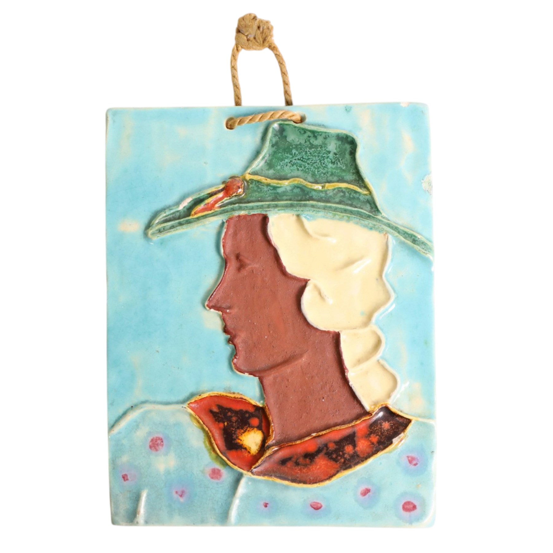 German Art Deco wall plaque, decorated with a female figure, in a hat upon a blue ground, with retailers sticker to the back 'kunstgewerbehaus Rolshoven', H19cm 