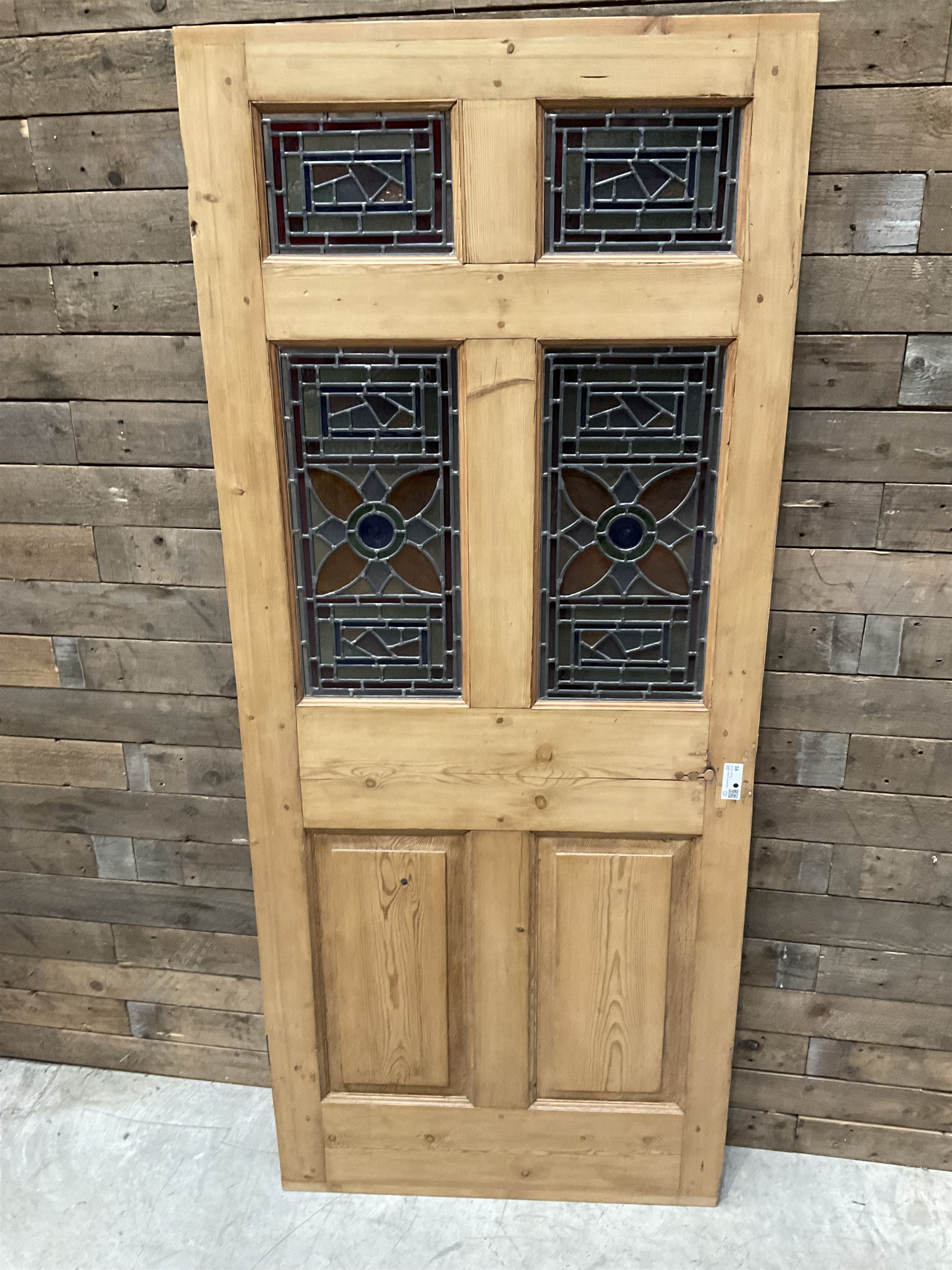 Early 20th century pine six panel door with later stained glass panels