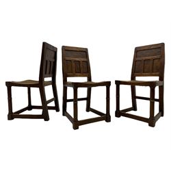 'Gnomeman' set of three oak dining chairs, panelled backs over curved seat rails with drop in rope rush seats, turned front supports with collar joined by plain stretchers, two with carved seated gnome figures, painted

Provenance - This collection of early 'Gnomeman' furniture comes to us directly from the Whittaker family. The pieces were made by the vendor's father Thomas Whittaker in the 1930/40s for his own use. During this time, he lived in York and made items for himself and friends. Whittaker adopted the gnome as a signature and trademark after his move to Littlebeck, Whitby.